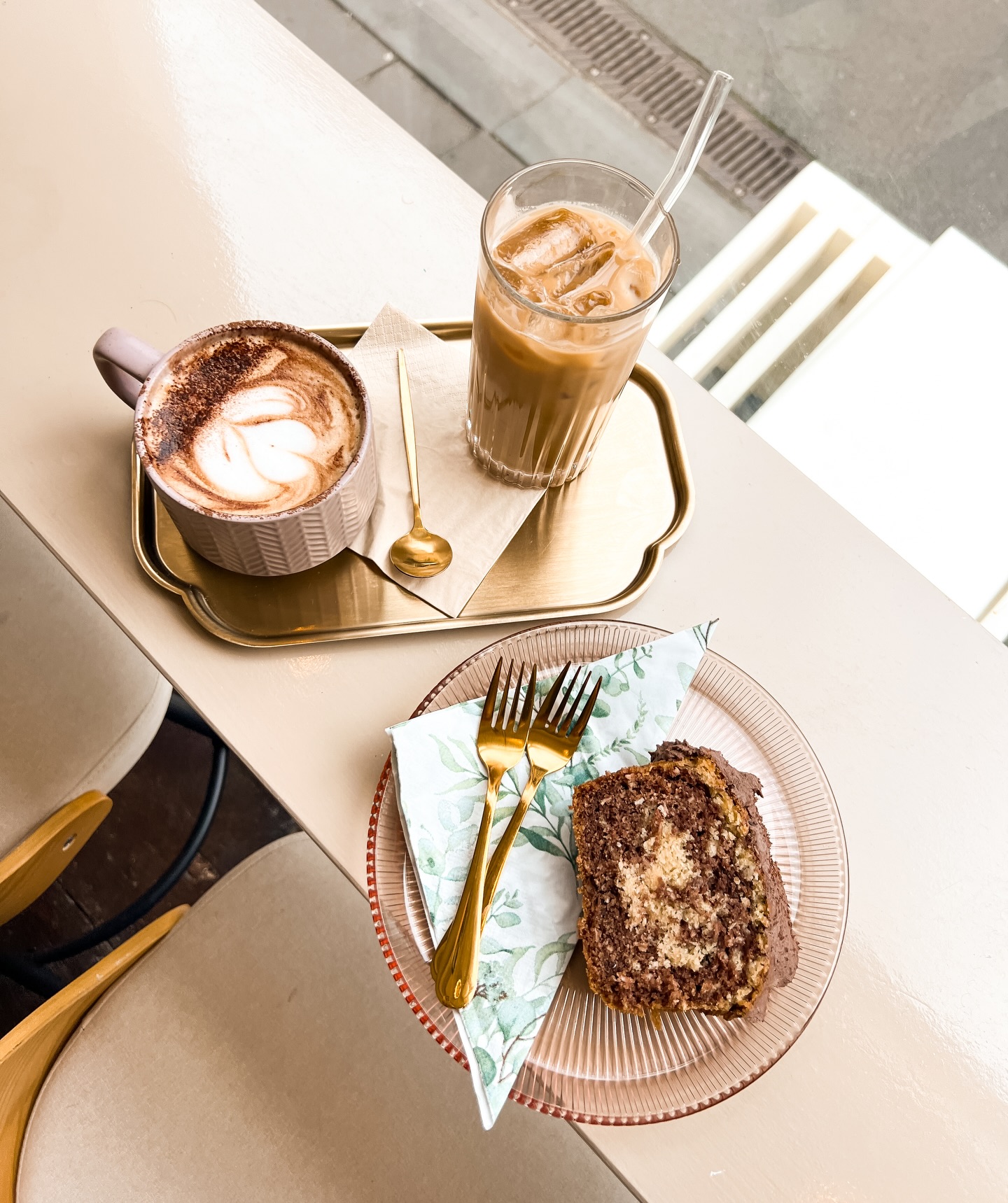 Coffee, iced coffee and a slice of cake served at Sonder